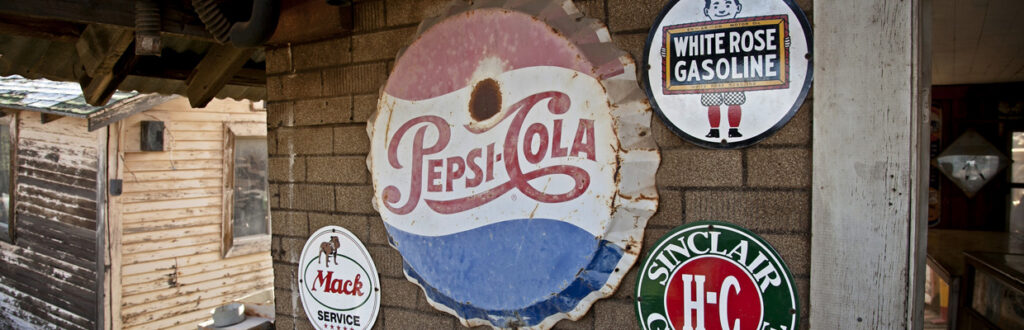 old metal signs adorn an old structure