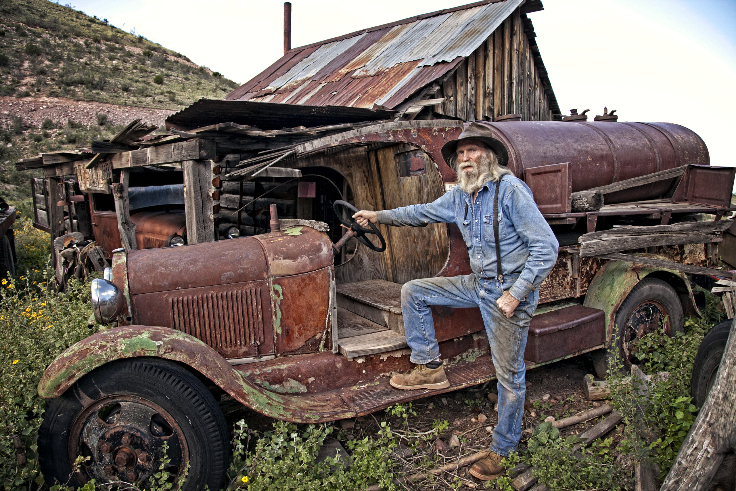 don robertson next to an old vehicle