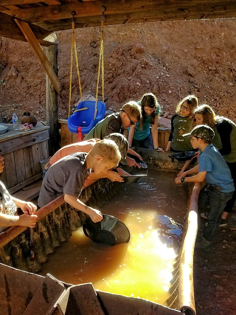 children eagerly gather at the sluice to pan for gold at the gold king mine and ghost town in jerome arizona