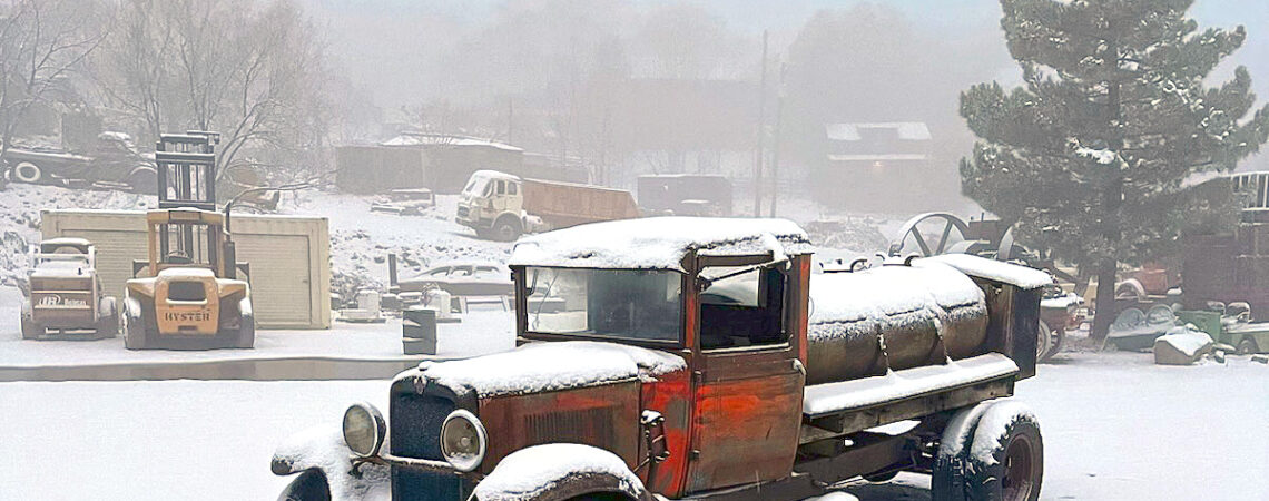 a 1932 chevy tanker truck sits in the snow after being trailered from Stillwater Minnesota
