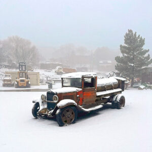 a 1932 chevy tanker truck sits in the snow after being trailered from Stillwater Minnesota